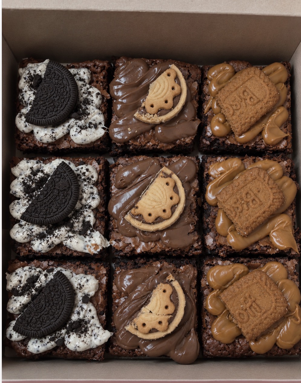 A real BakeToGive brownie box: nine brownies topped with cookies and cream, chocolate hazelnut and Biscoff